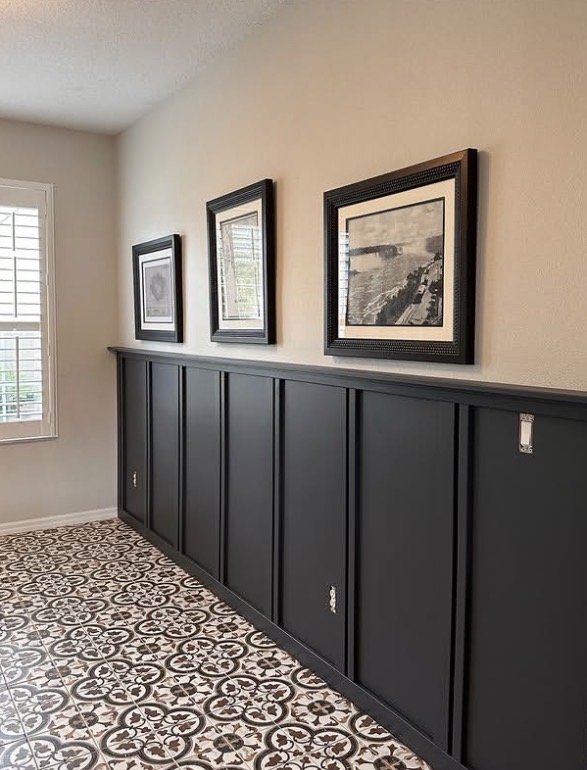 Black board and batten wainscoting with framed art