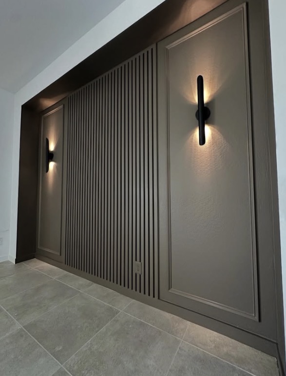 Taupe slat wall with sconces in hallway